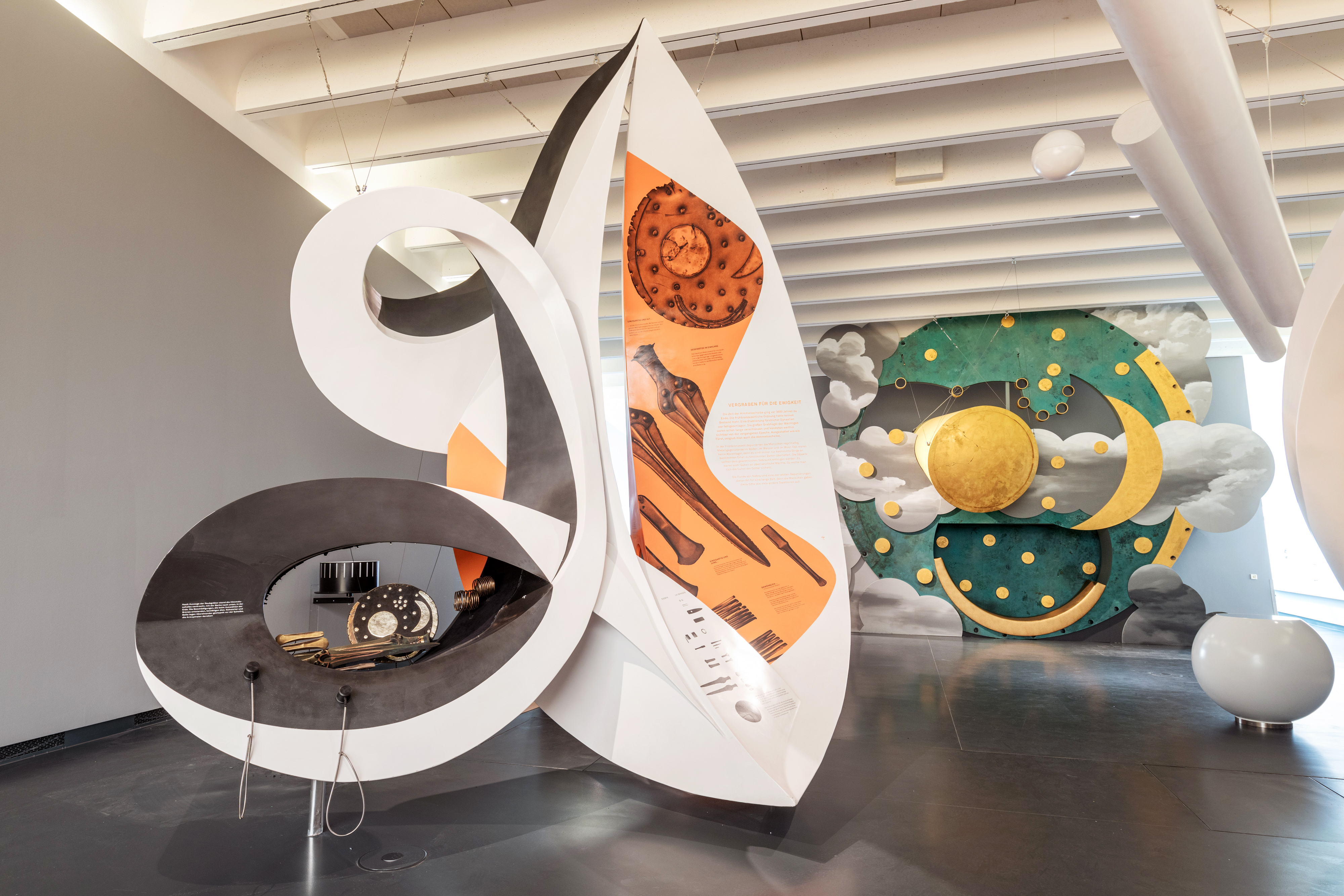 Blick in die Dauerpräsentation. Die Himmelsscheibe von Nebra wurde menschengroß nachgebaut. Davor befindet sich eine weiße Konstruktion mit Medienstation, die zusätzliche Informationen dazu liefert.